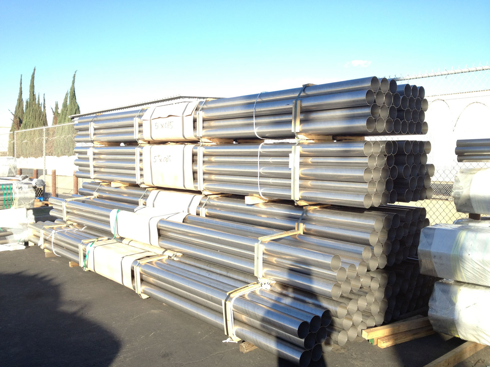 Stainless steel tubes stacked in Permagro's outdoor storage area