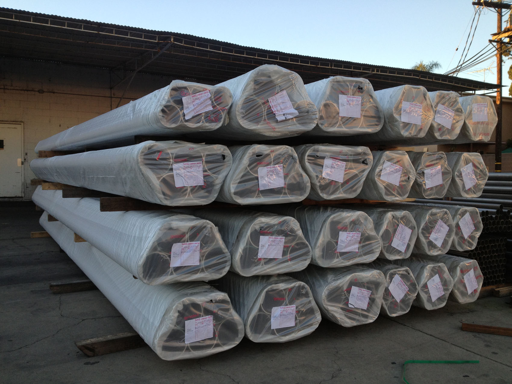 Wrapped stainless steel pipe bundles in outdoor storage