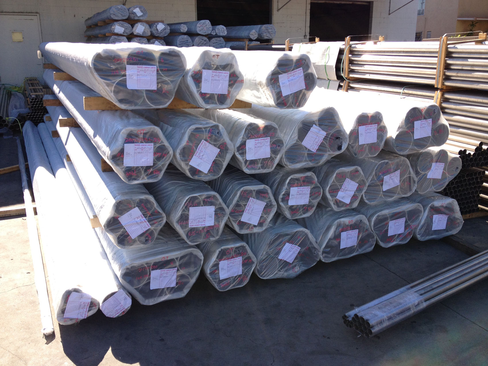 Wrapped stainless steel pipe bundles outside the warehouse